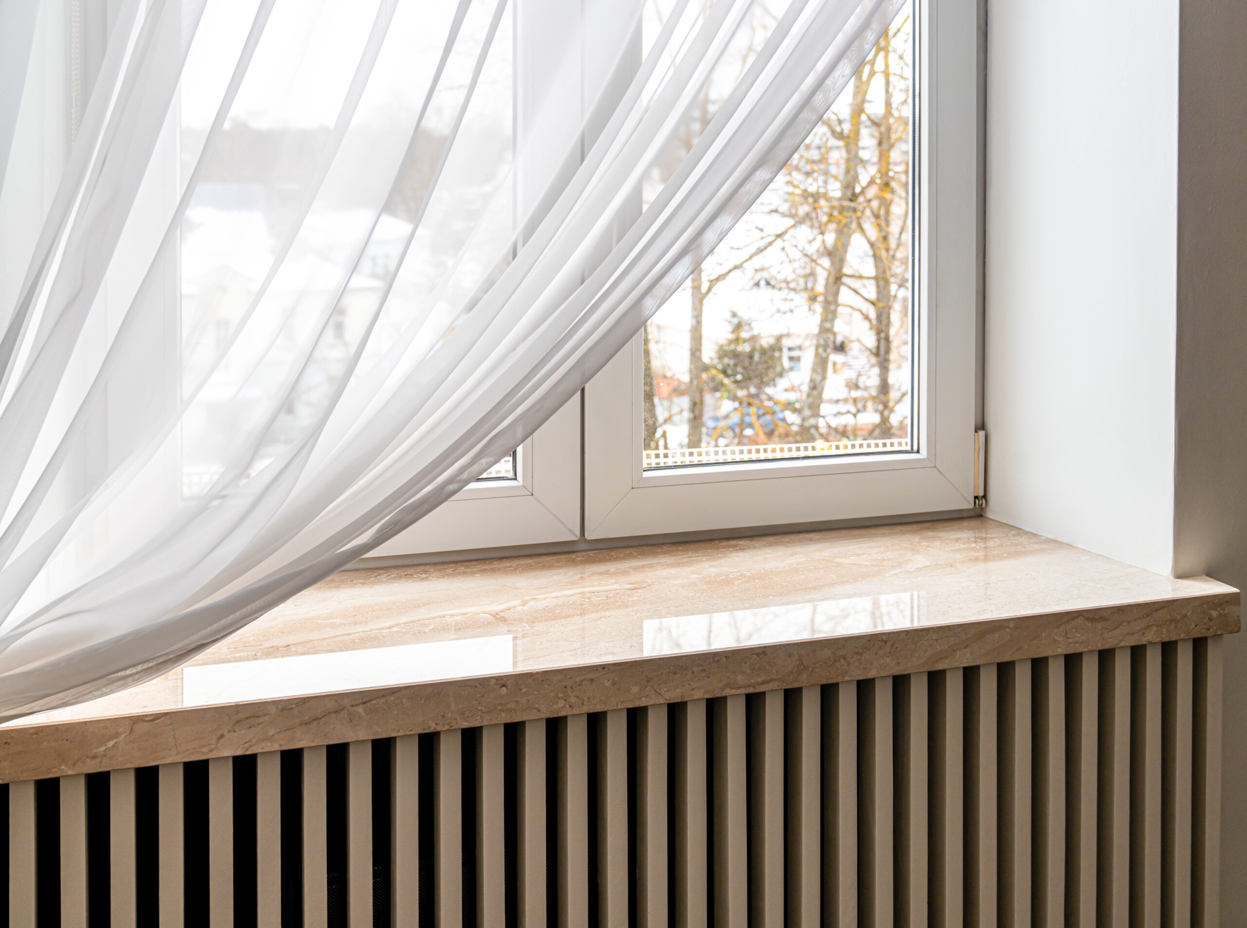 Modern window sill made of marble stone. Close-up shot